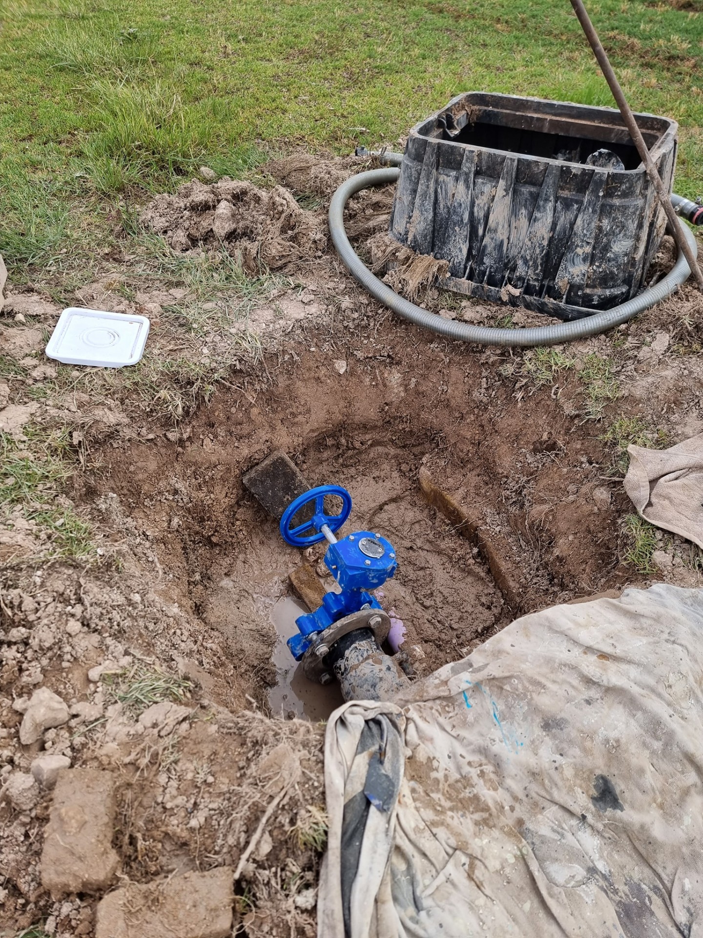 New mains water gate valve installed in a roadside pit