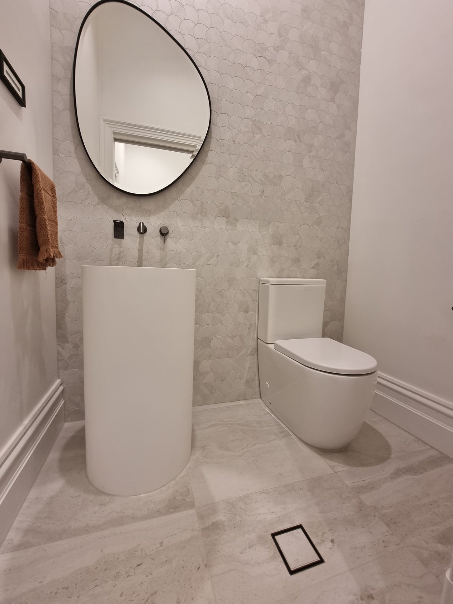 Designer powder room with floor-mounted pedestal basin