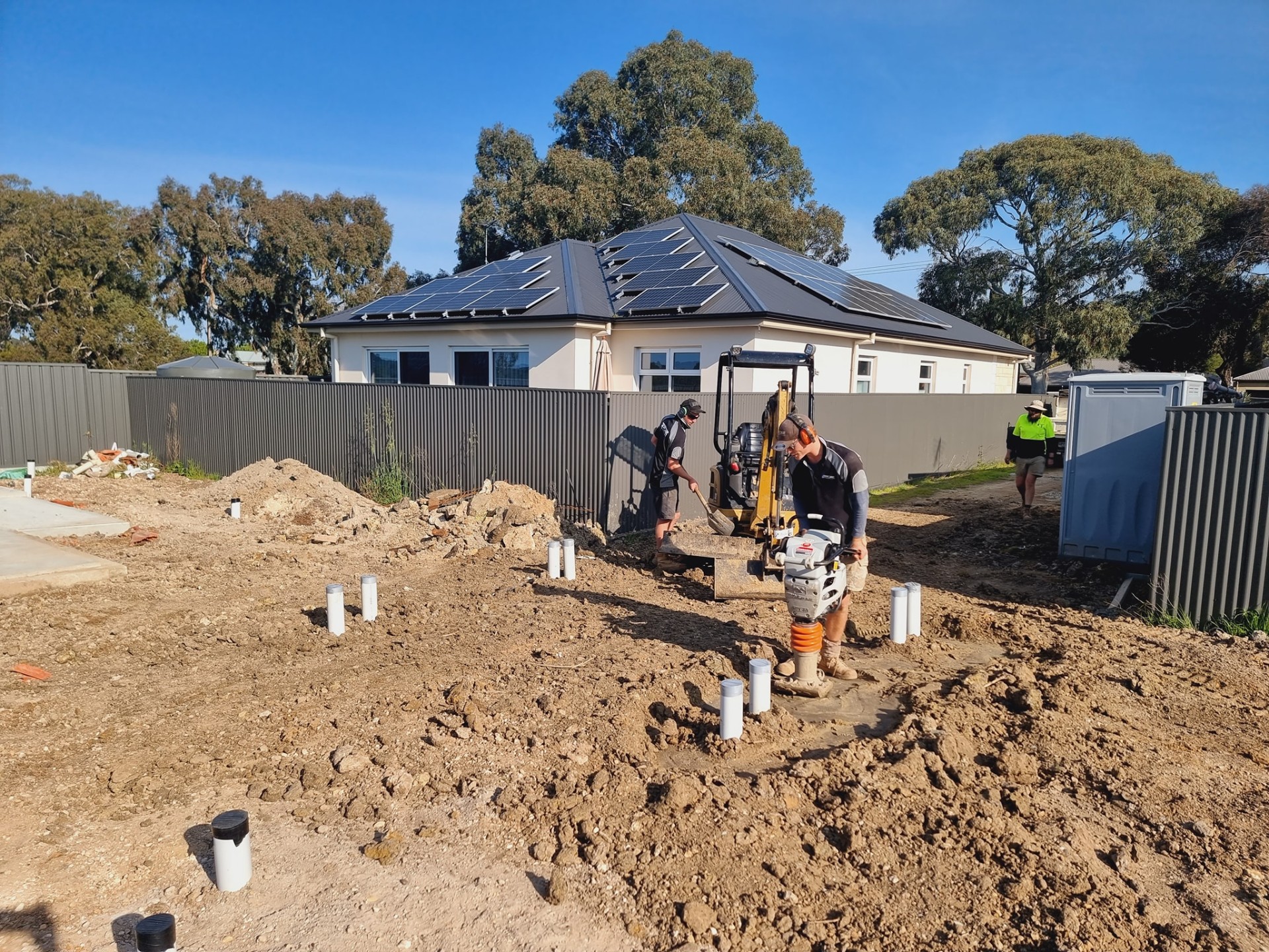 Topline crew compacting a site after a full sewer rough-in