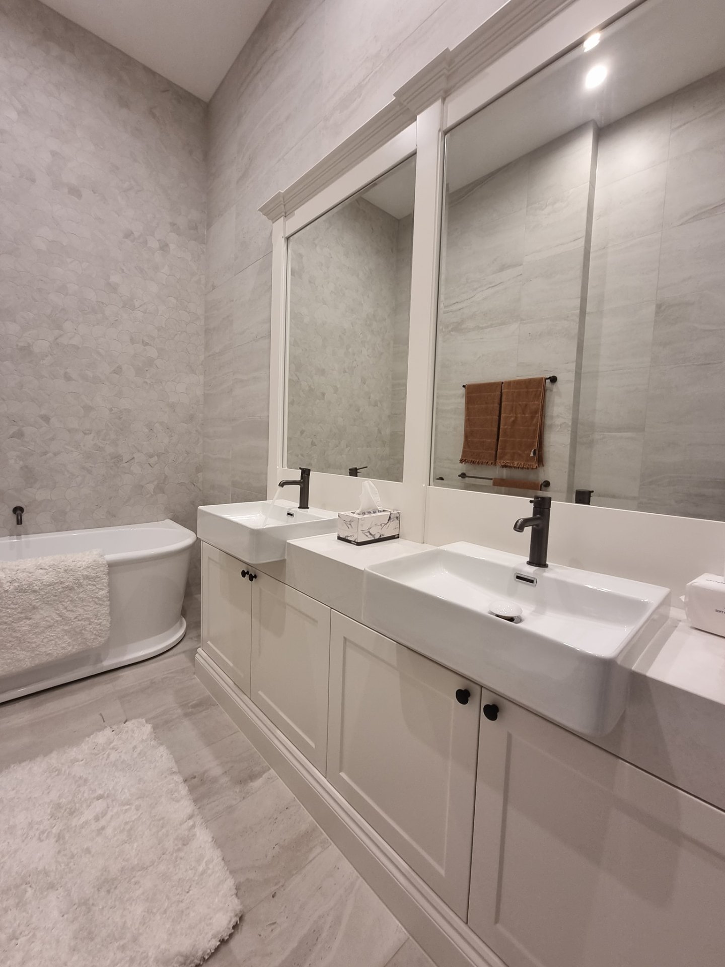 Twin vanity install with custom shaker cabinetry and stone top