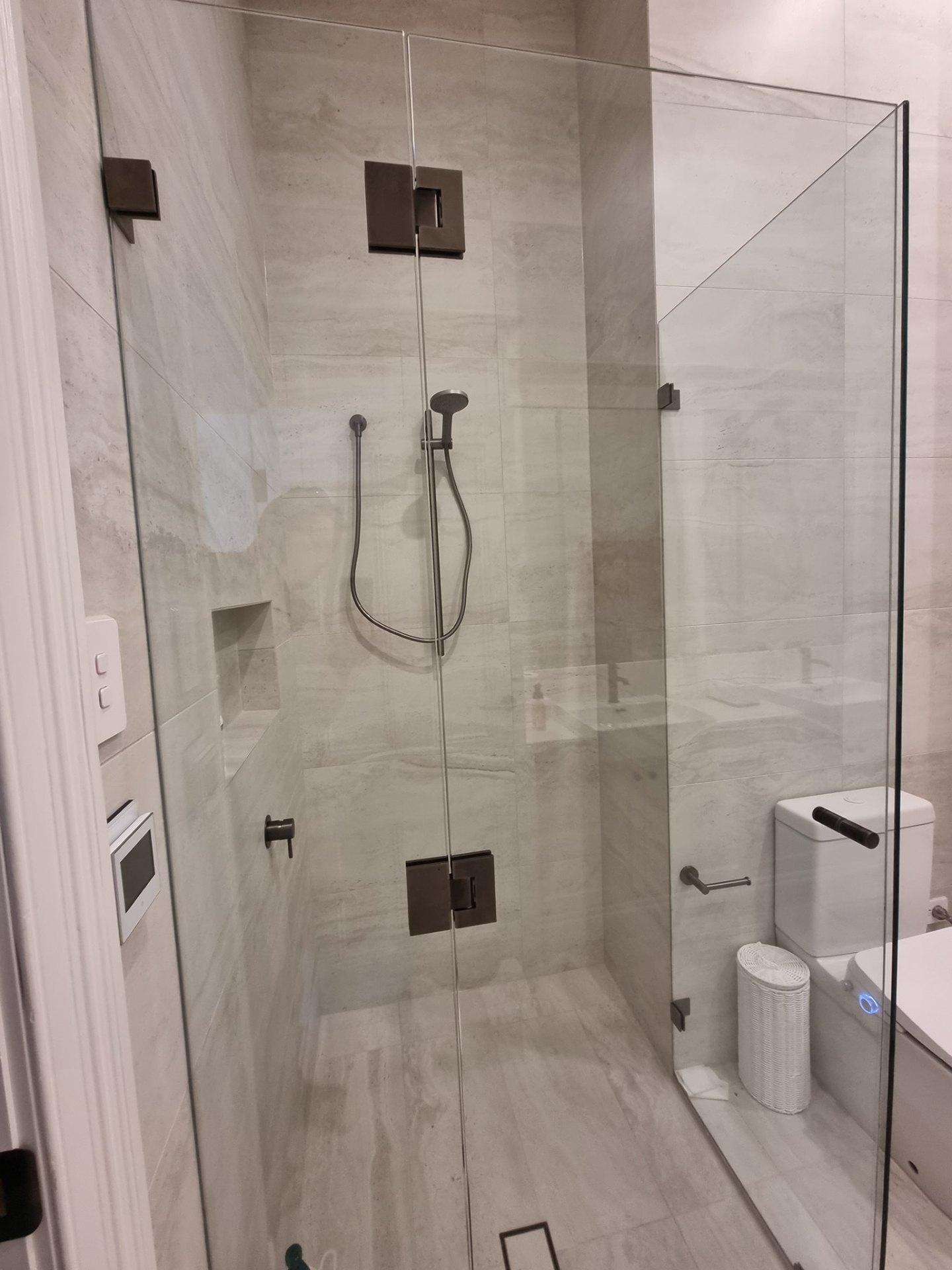 Frameless walk-in shower with matte black mixer and rail
